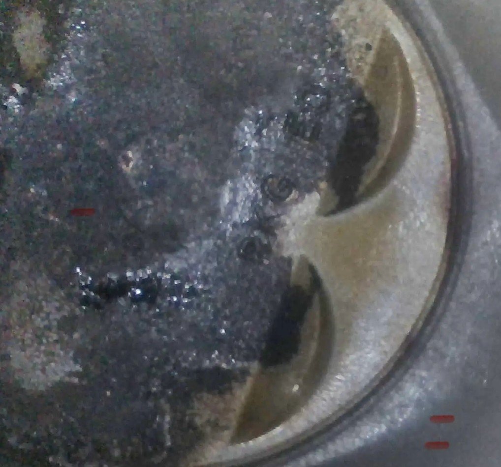 Piston crown before B-12 soak — carbon buildup